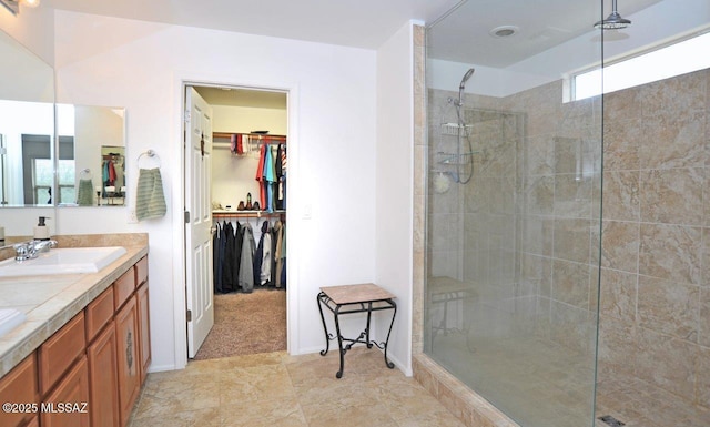 full bathroom with a sink, a walk in shower, double vanity, and a spacious closet
