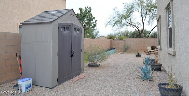 view of shed with a fenced backyard