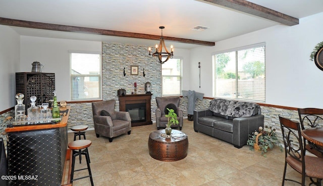 living area with visible vents, light tile patterned flooring, a chandelier, and beamed ceiling