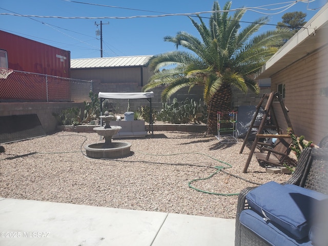 view of yard with fence and a playground