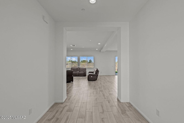 corridor featuring recessed lighting, light wood finished floors, and baseboards