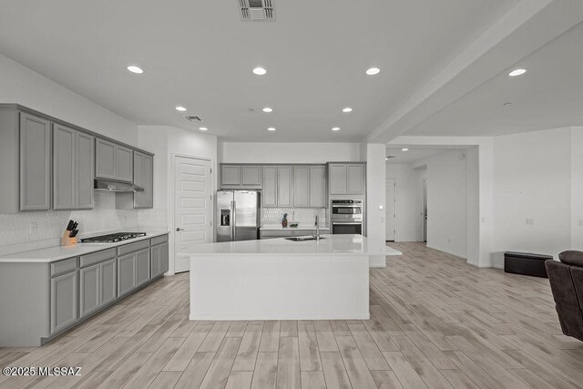 7956 S Desert Indigo Dr, Tucson, AZ 85747 - kitchen featuring stainless steel appliances, gray cabinets, open floor plan, tasteful backsplash, and recessed lighting