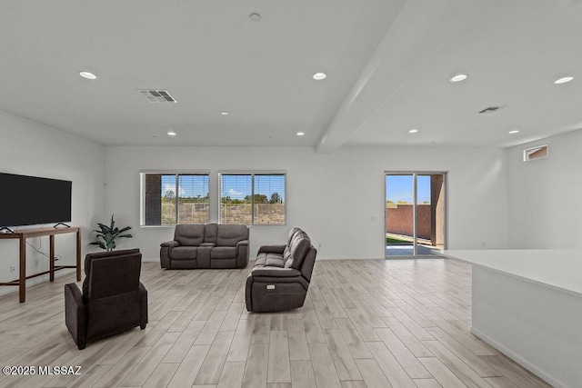 living area with recessed lighting, visible vents, and light wood-style floors