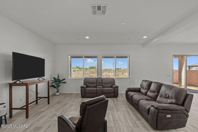 living room with recessed lighting, baseboards, light wood finished floors, and visible vents