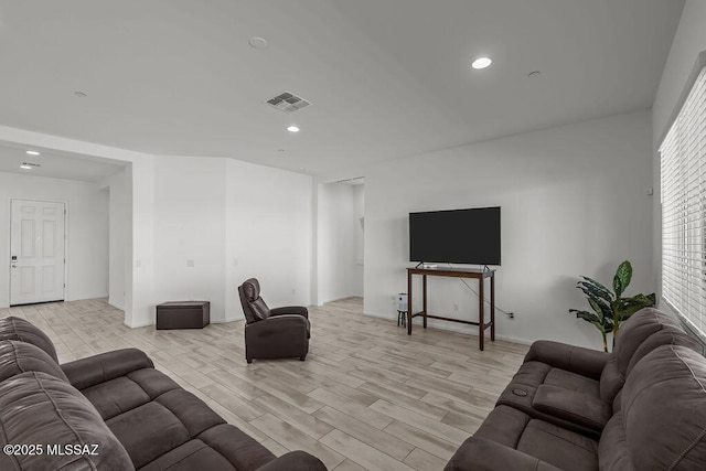 living area with baseboards, recessed lighting, light wood-style flooring, and visible vents