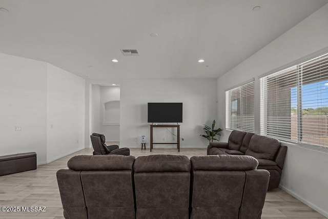 living room featuring recessed lighting, baseboards, and light wood-style floors