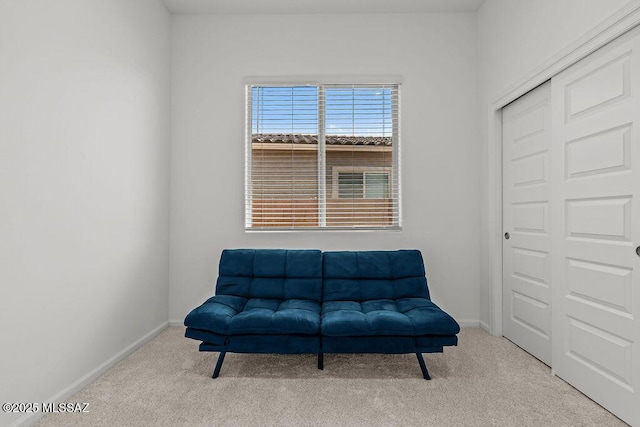 living area featuring carpet floors and baseboards