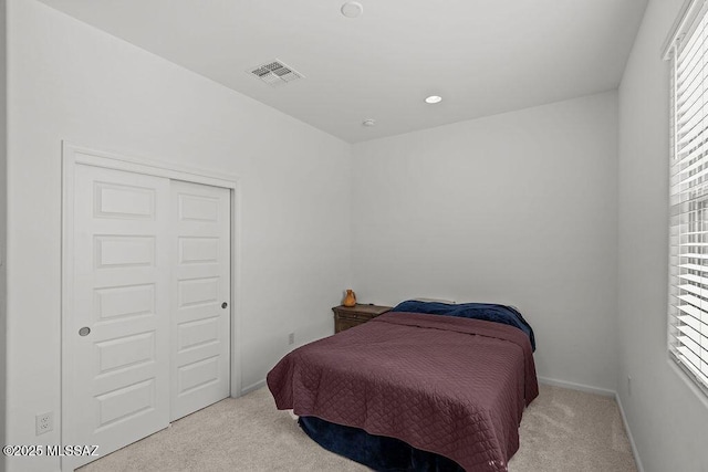 carpeted bedroom with baseboards and visible vents