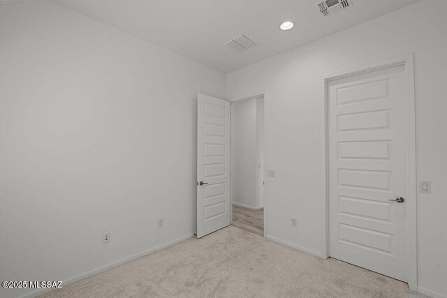 7956 S Desert Indigo Dr, Tucson, AZ 85747 - unfurnished bedroom with light colored carpet and recessed lighting