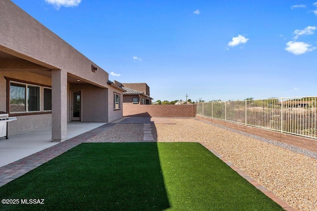 view of yard featuring a patio and a fenced backyard