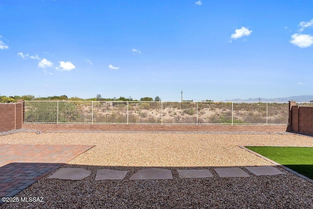 view of yard with a mountain view and a fenced backyard
