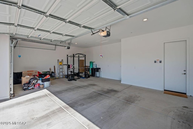 garage with recessed lighting and a garage door opener