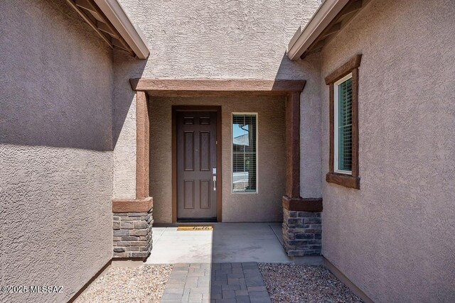 7956 S Desert Indigo Dr, Tucson, AZ 85747 - entrance to property with stucco siding and stone siding