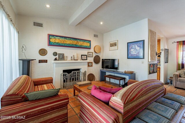 tiled living room with a fireplace with flush hearth, lofted ceiling with beams, and visible vents