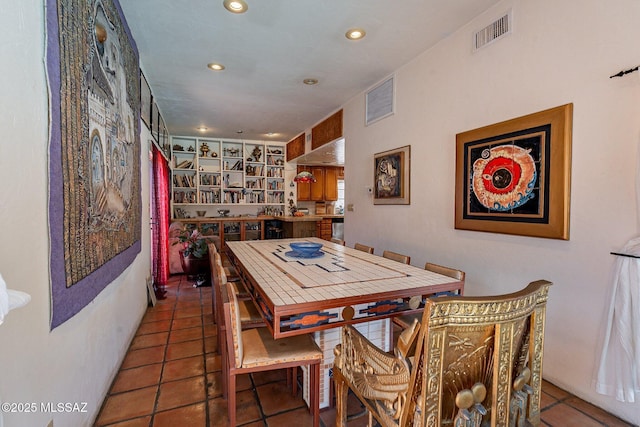 tiled dining room with visible vents and recessed lighting