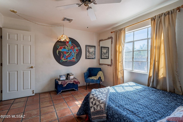 bedroom featuring visible vents, a ceiling fan, and tile patterned floors