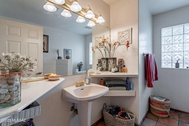 bathroom featuring an inviting chandelier, tile patterned floors, visible vents, and a wealth of natural light