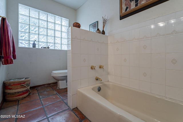 full bathroom featuring toilet and a garden tub