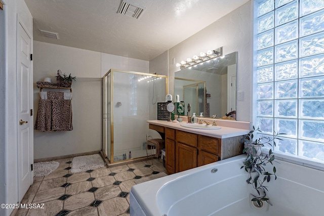 full bath with vanity, tile patterned floors, a shower stall, visible vents, and a bath