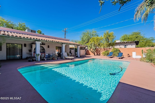 view of swimming pool with a patio, fence, and a fenced in pool