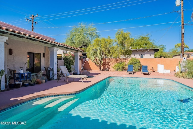 view of swimming pool featuring a patio, a fenced in pool, and a fenced backyard