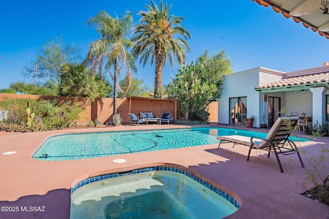 view of pool featuring a fenced in pool, a fenced backyard, an in ground hot tub, and a patio