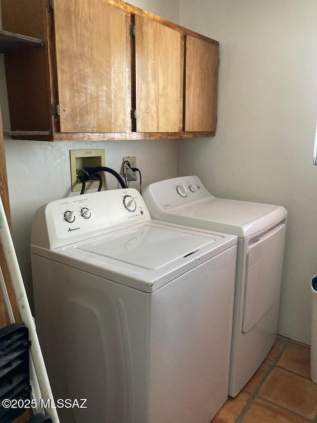 washroom featuring cabinet space and washer and dryer