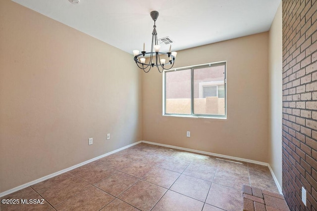 empty room with tile patterned flooring, a notable chandelier, baseboards, and visible vents