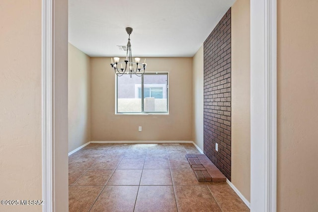 unfurnished dining area with visible vents, baseboards, tile patterned floors, and a chandelier