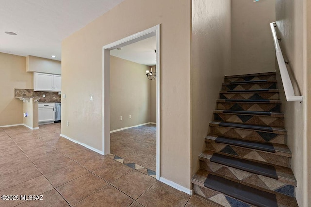 stairs with an inviting chandelier, tile patterned floors, baseboards, and recessed lighting