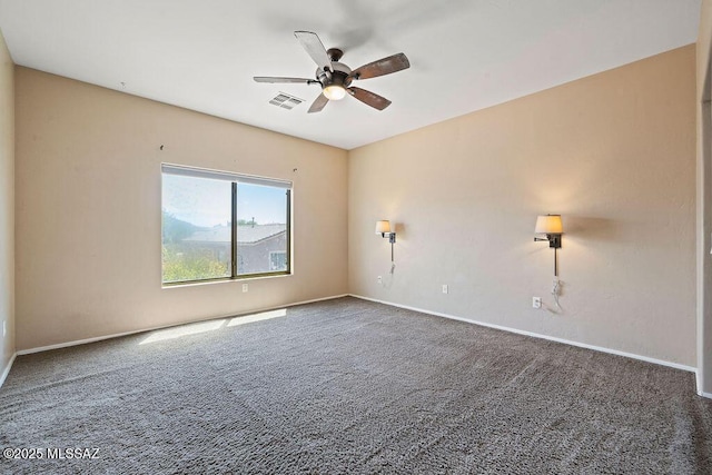 carpeted empty room with visible vents, a ceiling fan, and baseboards