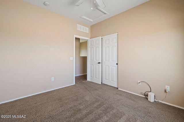unfurnished bedroom with carpet floors, baseboards, and visible vents