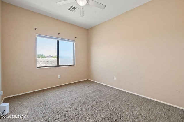 empty room featuring carpet floors, ceiling fan, baseboards, and visible vents