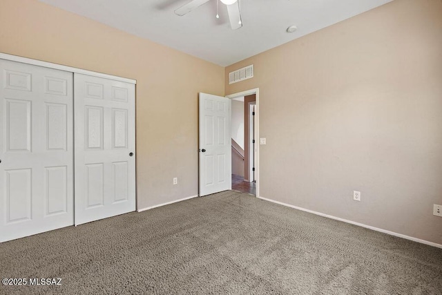 unfurnished bedroom featuring visible vents, a ceiling fan, a closet, baseboards, and carpet flooring