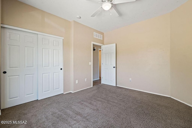 unfurnished bedroom featuring visible vents, carpet flooring, baseboards, and a closet