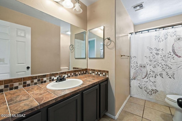 full bathroom featuring visible vents, vanity, curtained shower, toilet, and tile patterned floors
