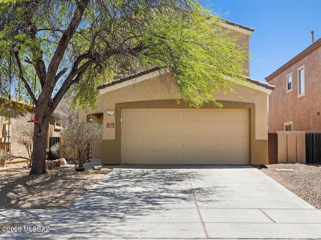view of front of property featuring stucco siding, an attached garage, and driveway