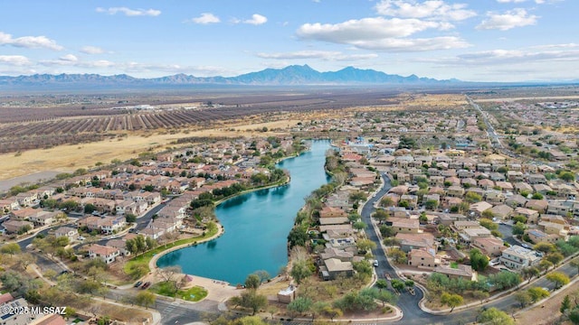 drone / aerial view with a water and mountain view and a residential view