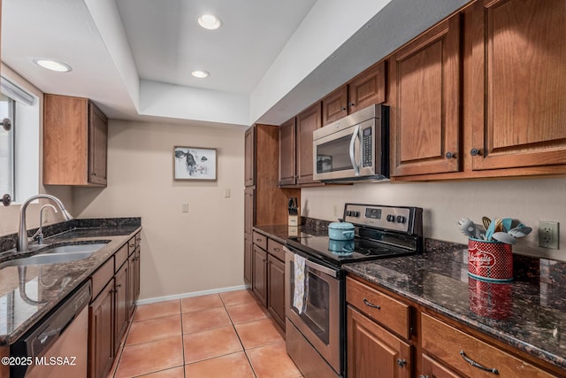 1734 N Van Buren Ave, Tucson, AZ 85712 - kitchen featuring dark stone counters, appliances with stainless steel finishes, and a sink