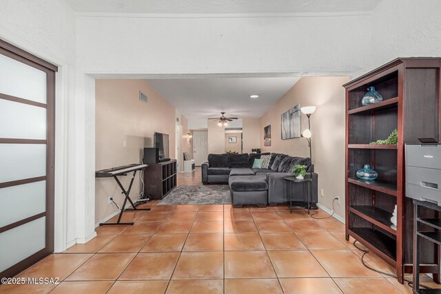 1734 N Van Buren Ave, Tucson, AZ 85712 - living room with light tile patterned floors, baseboards, a ceiling fan, and visible vents
