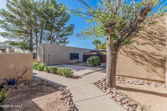 1734 N Van Buren Ave, Tucson, AZ 85712 - view of side of home with a patio, fence, and stucco siding