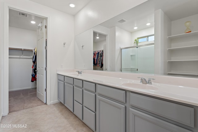 10337 S Pantano Knolls Dr, Vail, AZ 85641 - bathroom featuring double vanity, visible vents, a shower stall, a sink, and baseboards