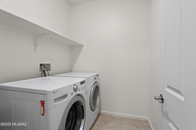 10337 S Pantano Knolls Dr, Vail, AZ 85641 - laundry area with light tile patterned floors, separate washer and dryer, baseboards, and laundry area