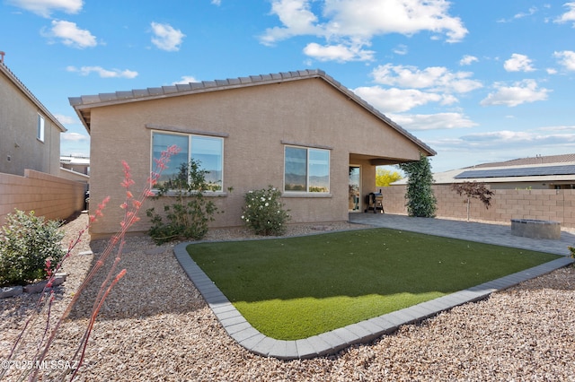 10337 S Pantano Knolls Dr, Vail, AZ 85641 - rear view of house featuring a lawn, fence private yard, a patio area, and stucco siding