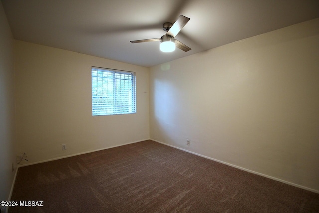 8133 E Colette Pl, Tucson, AZ 85710 - empty room featuring dark carpet, a ceiling fan, and baseboards