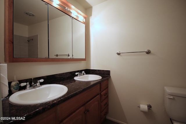 8133 E Colette Pl, Tucson, AZ 85710 - bathroom featuring double vanity, toilet, and a sink