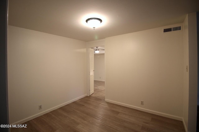 8133 E Colette Pl, Tucson, AZ 85710 - empty room featuring baseboards, wood finished floors, and visible vents