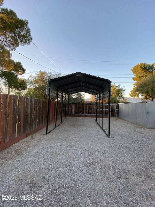 8133 E Colette Pl, Tucson, AZ 85710 - view of parking featuring fence, a detached carport, and driveway