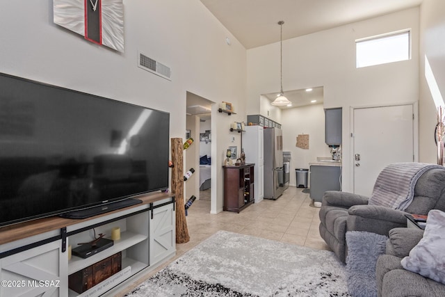 1810 E Blacklidge Dr Apt 827, Tucson, AZ 85719 - living area with visible vents, light tile patterned floors, and a high ceiling
