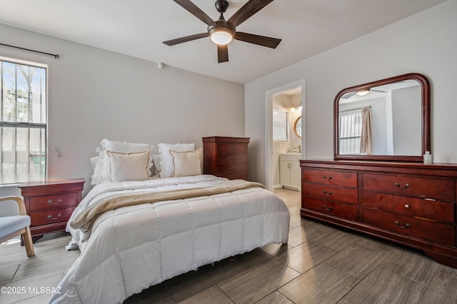 bedroom with ensuite bathroom and a ceiling fan